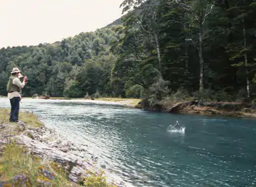 Angler fishing clear water on an international fly fishing trip