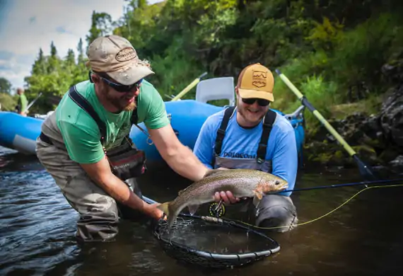 Guide helping an angler release a Copper River rainbow trout